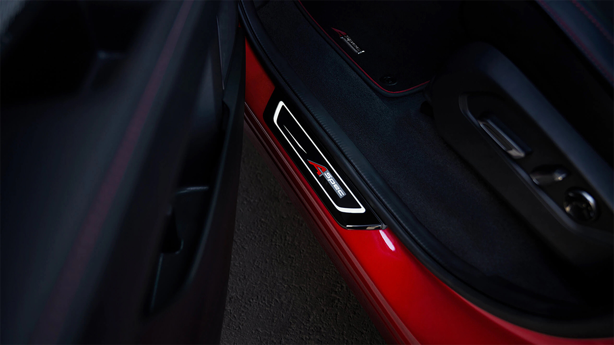 An open driver's side door reveals the A-SPEC badging on the bottom of the door frame.