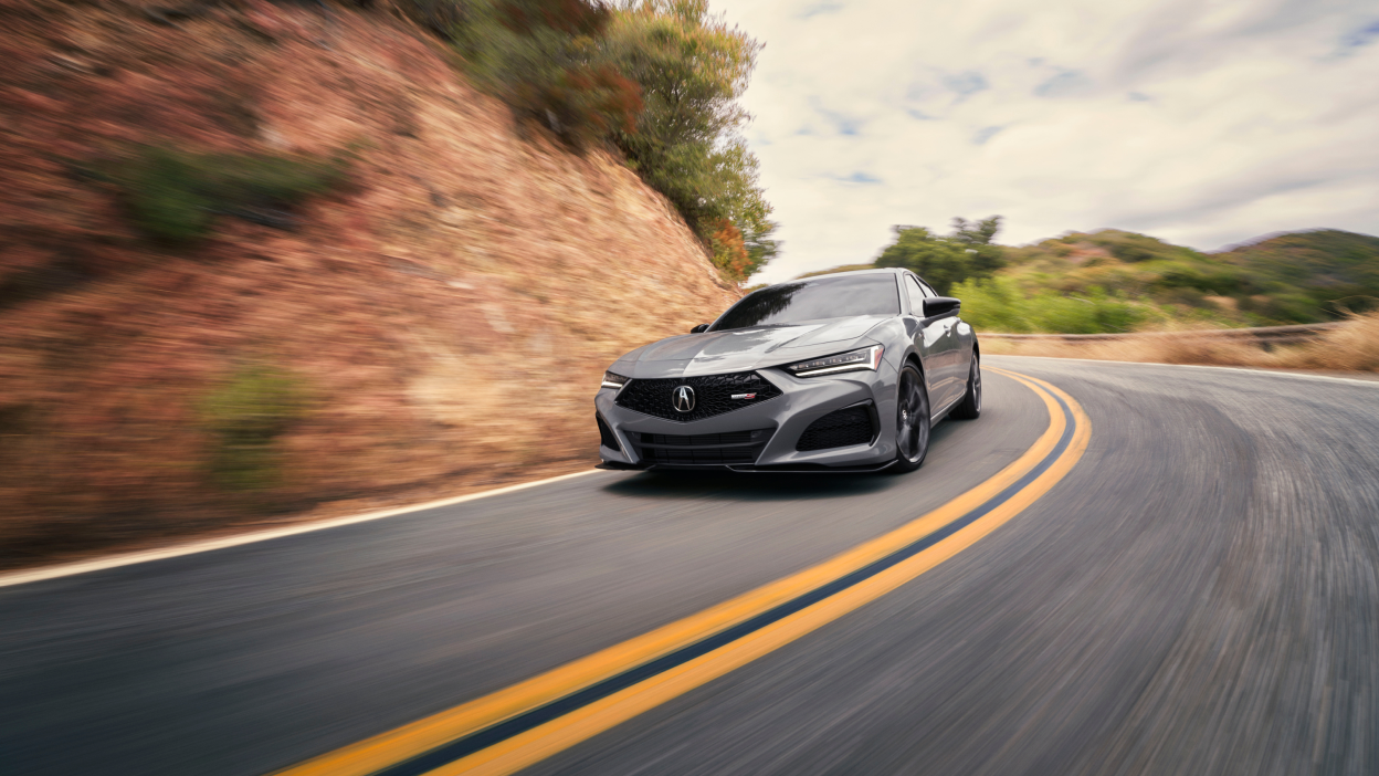Front view of grey TLX Type S taking a turn on highway.