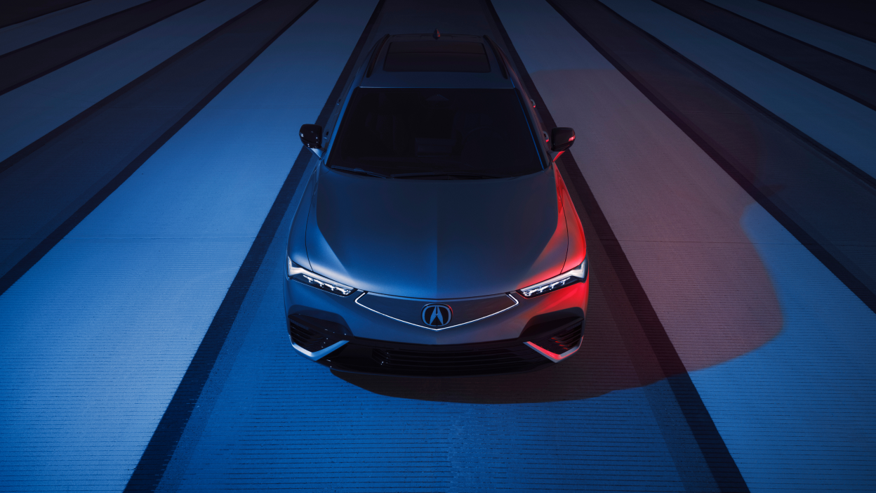 3/4 bird’s eye front view of blue ZDX on a concrete path.