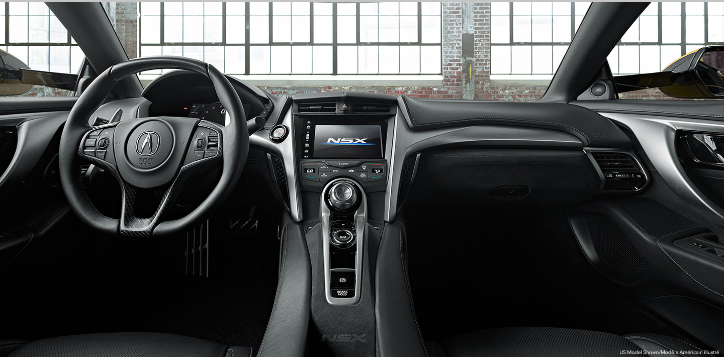 The interior of an Acura's cockpit from the backseat. / Vue du cockpit d’une Acura à partir de la banquette arrière.